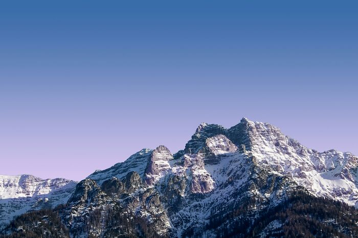 Snow-covered mountain peaks under a clear sky, illustrating crazy but real historical events in nature's backdrop.