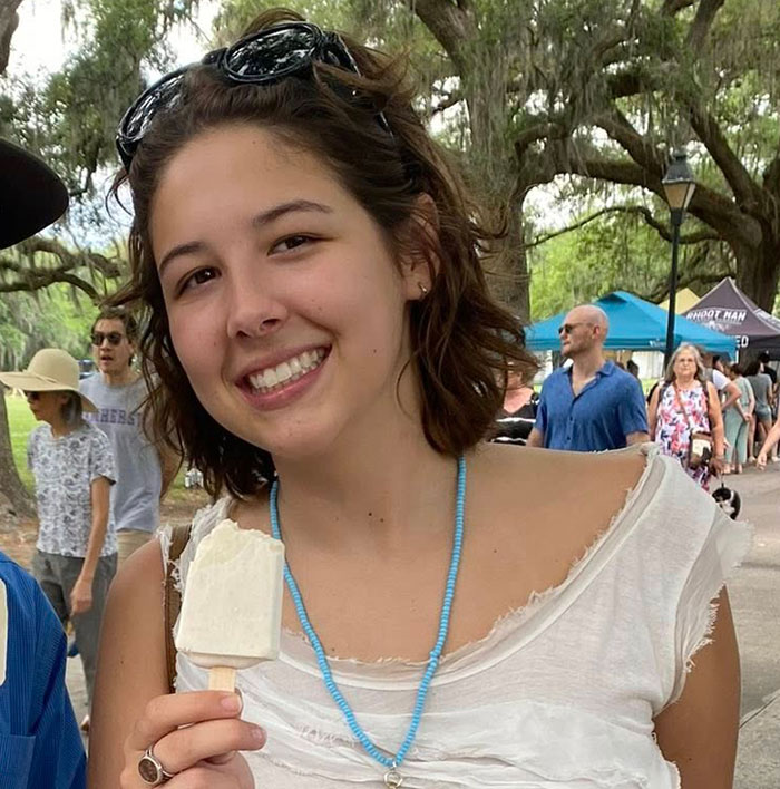 Young woman smiling outdoors at a park event, reflecting on the fear young flood victim must have felt. Young woman smiling outdoors at a park event, reflecting on the fear young flood victim must have felt.