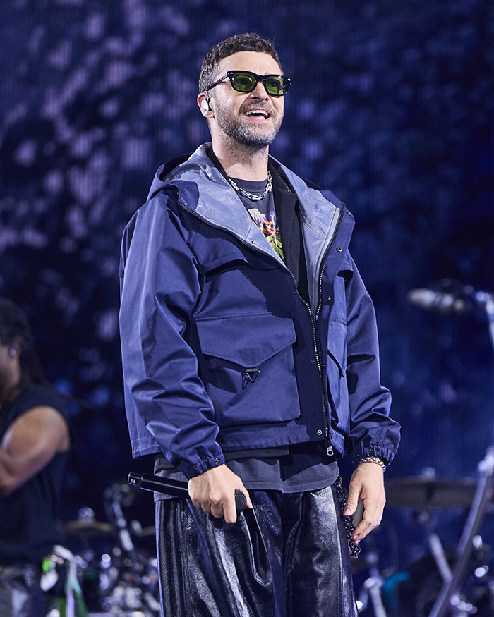 Justin Timberlake performing on stage, wearing sunglasses and a navy jacket, revealing Lyme disease battle in recent post. Justin Timberlake performing on stage, wearing sunglasses and a navy jacket, revealing Lyme disease battle in recent post.