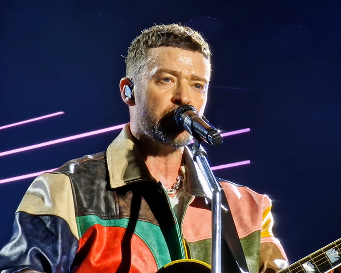 Justin Timberlake performing live on stage, wearing a colorful leather jacket, sharing his Lyme disease battle. Justin Timberlake performing live on stage, wearing a colorful leather jacket, sharing his Lyme disease battle.