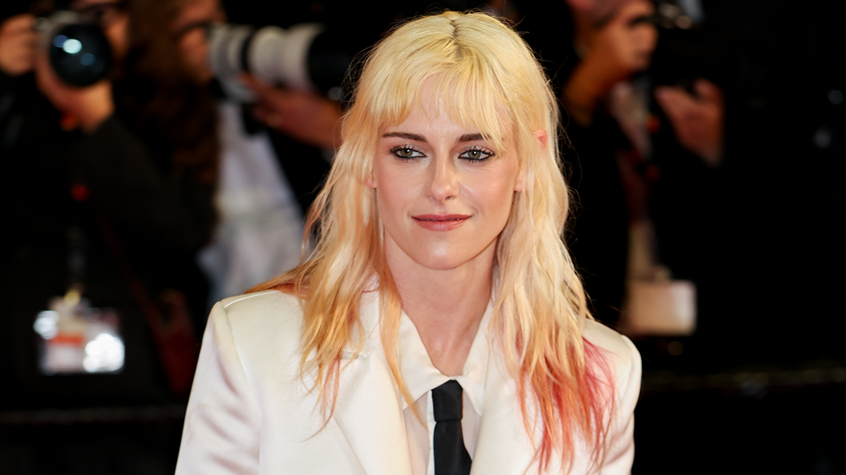 Kristen Stewart stuns fans with dramatic transformation, walking the dog outdoors with new wife, dressed in white suit.