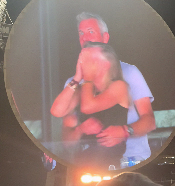 Couple embracing at a concert with a blurry effect, related to Coldplay cheating scandal HR executive Boston families. Couple embracing at a concert with a blurry effect, related to Coldplay cheating scandal HR executive Boston families.
