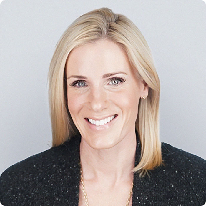 Smiling woman with blonde hair wearing a black jacket, related to wife of CEO accused of cheating scandal. Smiling woman with blonde hair wearing a black jacket, related to wife of CEO accused of cheating scandal.