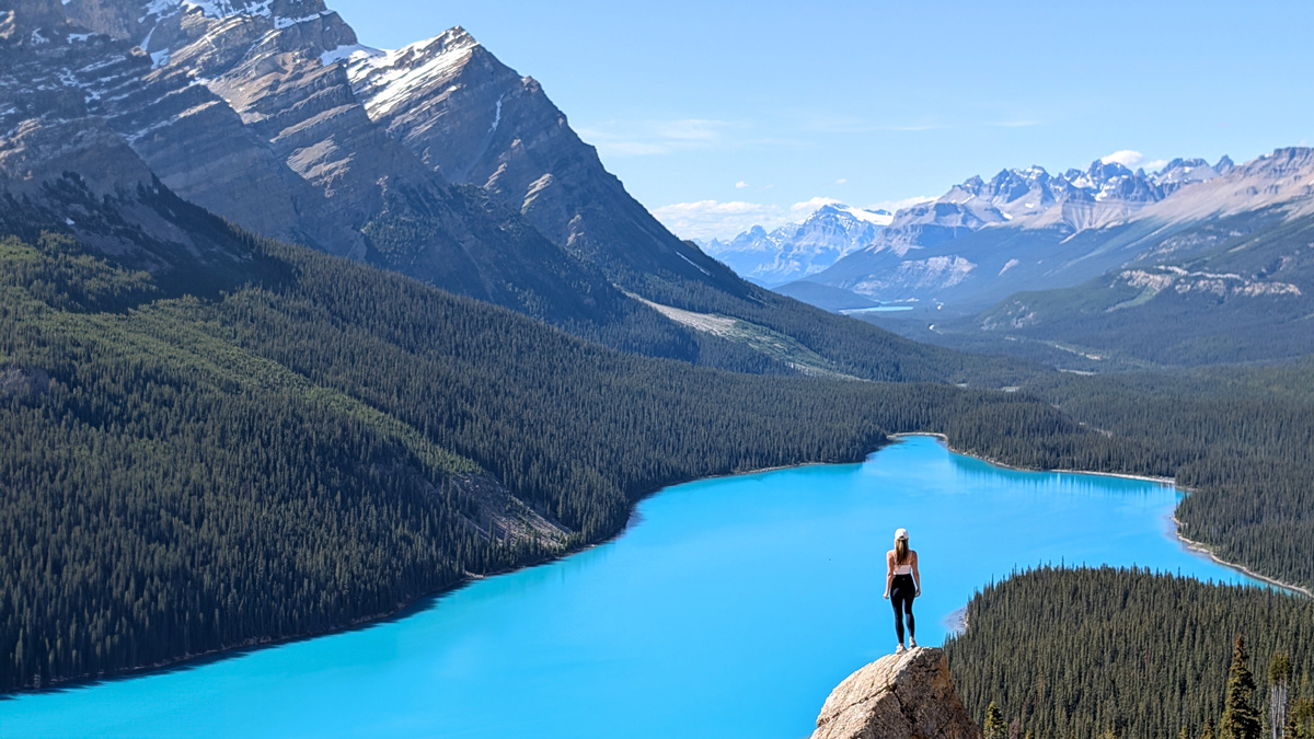 Hiker overlooking one of the easiest scenic spots in the Rockies with turquoise lake and rugged mountain views.