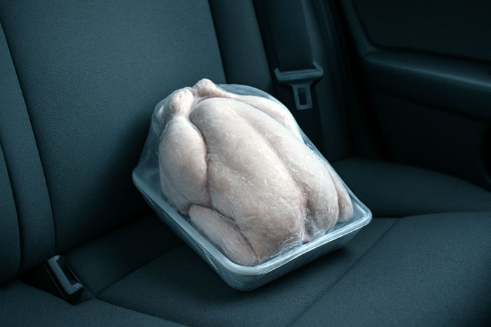 Raw chicken in plastic tray left on car seat trunk, husband declares it biohazard and refuses dinner over safety concerns. Raw chicken in plastic tray left on car seat trunk, husband declares it biohazard and refuses dinner over safety concerns.