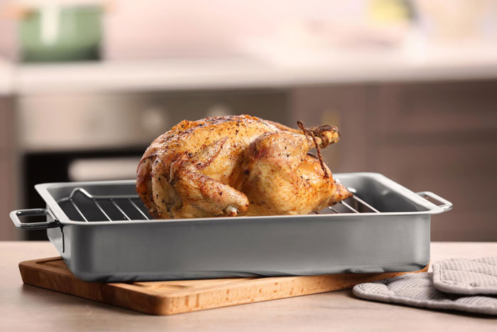 Roasted chicken cooling in a pan, illustrating concerns about raw chicken left in trunk and biohazard risks. Roasted chicken cooling in a pan, illustrating concerns about raw chicken left in trunk and biohazard risks.