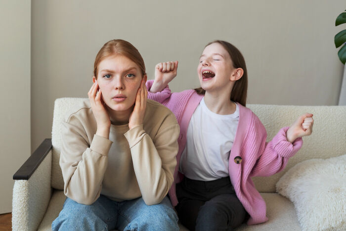 Two girls on a couch showing contrasting emotions, illustrating advice kids were given and manipulation in disguise.