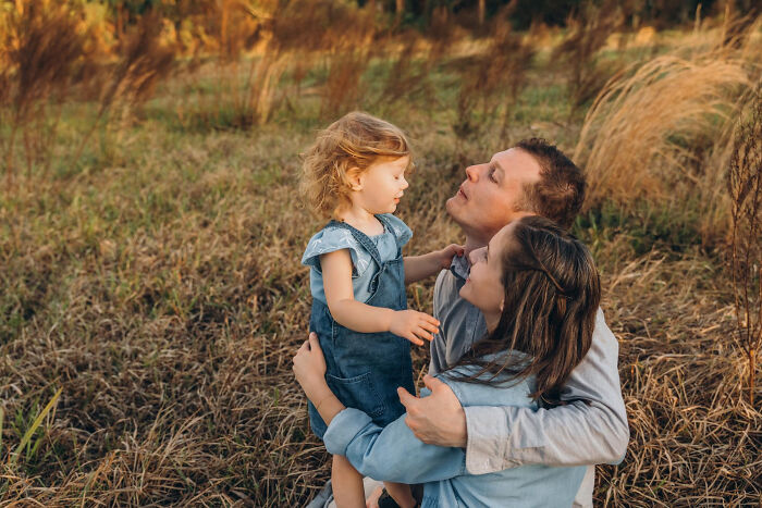 Family embracing in a field, illustrating advice kids were given that they later realized was manipulation in disguise.