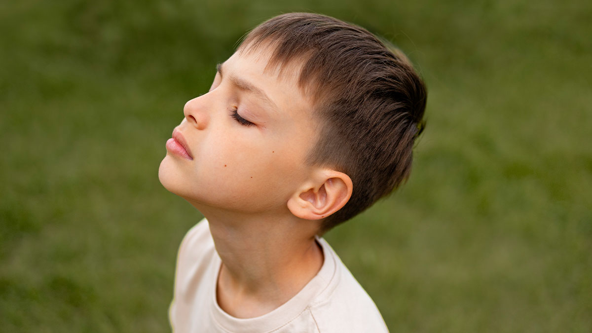 Young boy with closed eyes in a peaceful outdoor setting reflecting on advice kids realized was manipulation in disguise