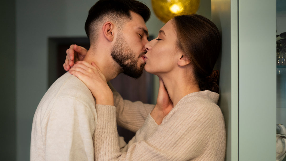 Couple sharing a tender kiss at home, illustrating themes of love and wifeu2019s infidelity in long-term marriages.