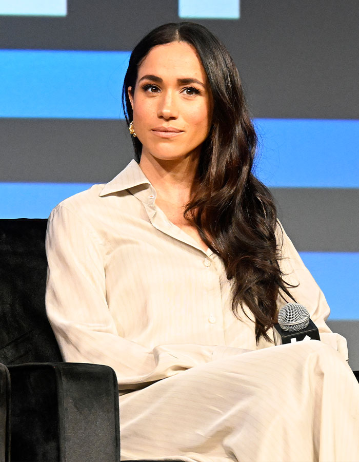 Woman with long dark hair wearing a cream blouse seated, related to Kate Middleton’s ex-assistant and Meghan Markle news event. Woman with long dark hair wearing a cream blouse seated, related to Kate Middleton’s ex-assistant and Meghan Markle news event.