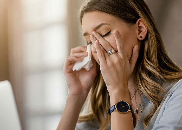 Woman battling cancer wiping tears with tissue, showing emotional struggle while asking for help at home. Woman battling cancer wiping tears with tissue, showing emotional struggle while asking for help at home.