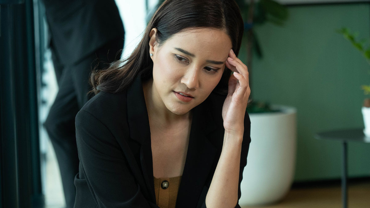 Woman looking distressed indoors, reflecting family drama over stolen grandsonu2019s ashes and emotional conflict.