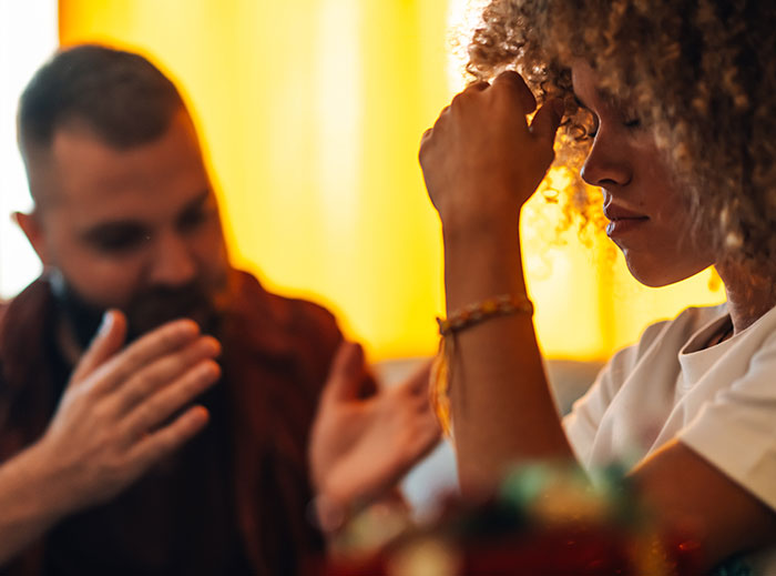 Frustrated woman and man arguing indoors, illustrating family drama and conflict after stealing grandson’s ashes.