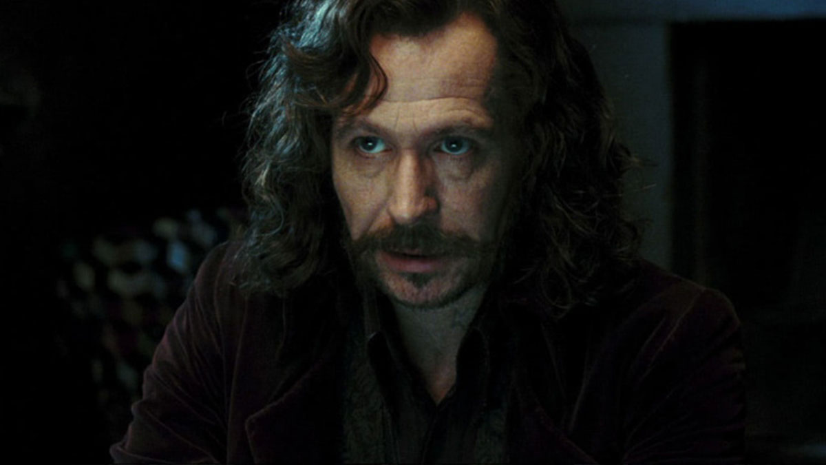 Man with long curly hair and mustache in dim light, highlighting a mind-blowing realization about the same actor.