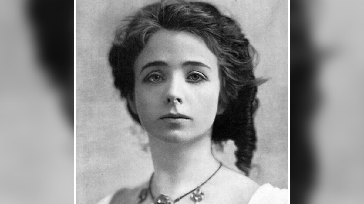 Black and white century-old photo of a woman representing timeless beauty with detailed hairstyle and classic expression