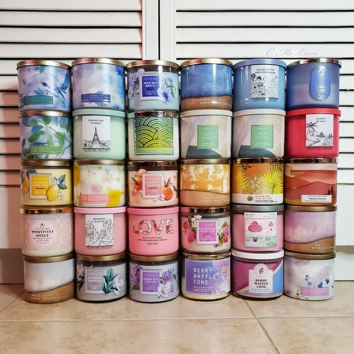 Stack of colorful scented candles representing trends in overconsumption leading to consumer fatigue and desire to stop buying.