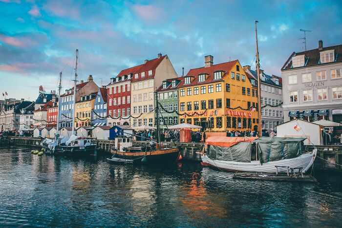 Colorful waterfront buildings and boats at a harbor in one of the smartest countries shaping the future of the world.