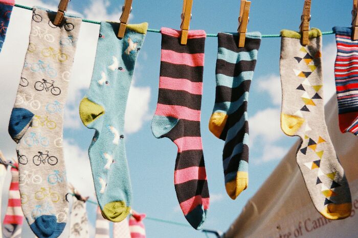 Colorful patterned socks hanging on a clothesline under blue sky, symbolizing outrageous student names revealed by a teacher.