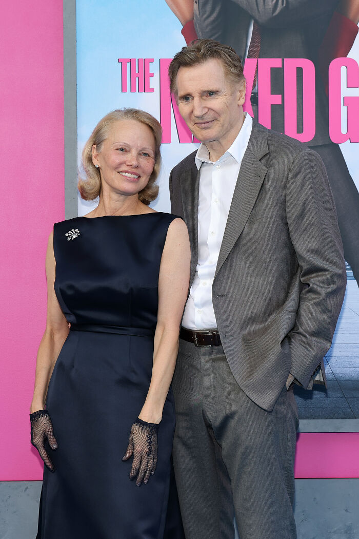 Pamela Anderson and Liam Neeson posing together at an event, linked to dating rumors and public sightings. Pamela Anderson and Liam Neeson posing together at an event, linked to dating rumors and public sightings.