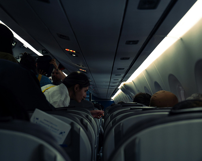 Passengers writing farewell messages inside a Japan Airlines flight during a sudden mid-air plunge event. Passengers writing farewell messages inside a Japan Airlines flight during a sudden mid-air plunge event.