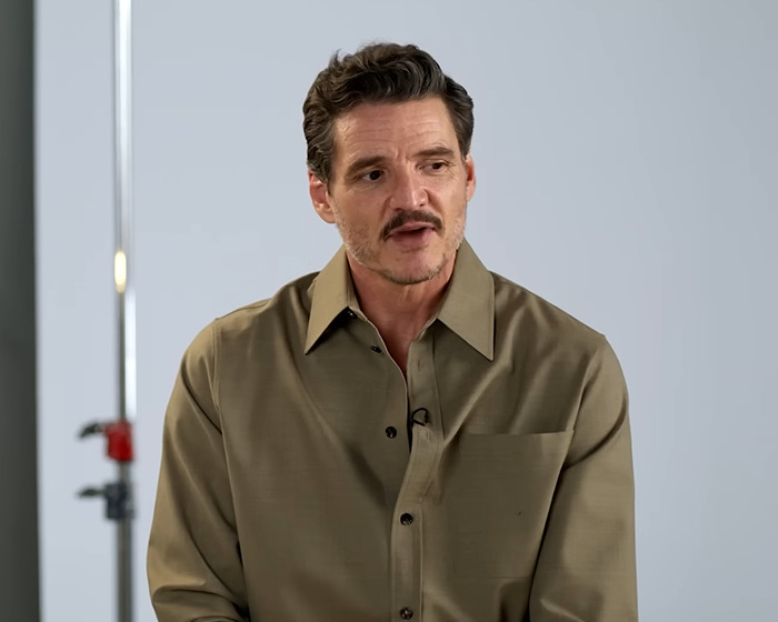 Pedro Pascal speaking during an interview, wearing a brown shirt, in a studio setting. Pedro Pascal speaking during an interview, wearing a brown shirt, in a studio setting.