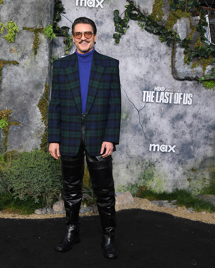 Pedro Pascal attending The Last of Us premiere in a plaid blazer and leather pants on a natural-themed red carpet. Pedro Pascal attending The Last of Us premiere in a plaid blazer and leather pants on a natural-themed red carpet.
