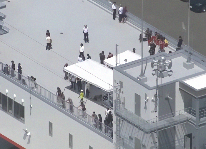 People gathered on ship deck as first tsunami waves hit Alaska following mega earthquake warnings. People gathered on ship deck as first tsunami waves hit Alaska following mega earthquake warnings.