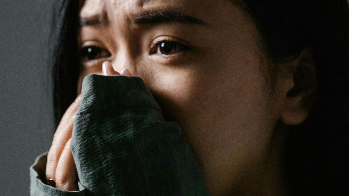 Close-up of a person showing fear and distress, illustrating real-life horror stories and unexplainable experiences.