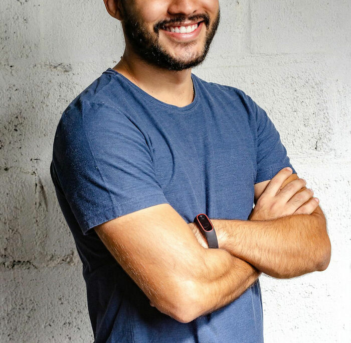 Man with arms crossed smiling confidently, symbolizing people who took revenge on their bosses.