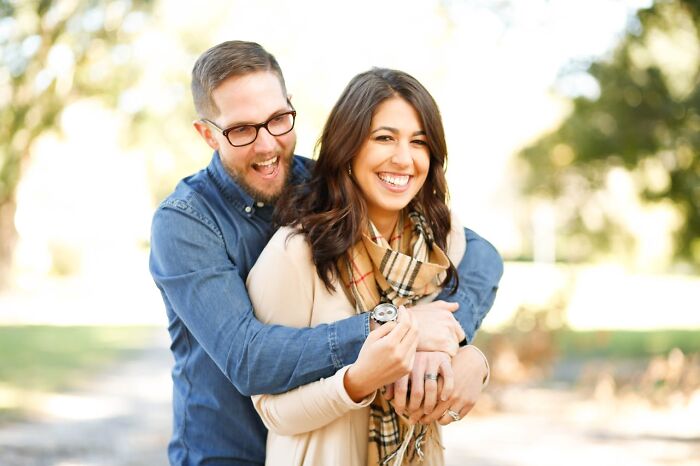 Couple outdoors smiling and enjoying a happy moment together, emphasizing the importance to stay hydrated.