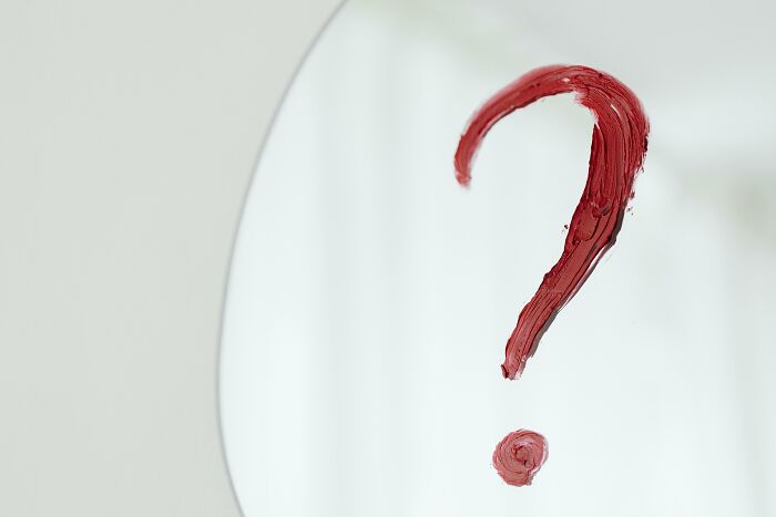 Red question mark painted on a mirror symbolizing true or false concept in a general knowledge challenge quiz. Red question mark painted on a mirror symbolizing true or false concept in a general knowledge challenge quiz.