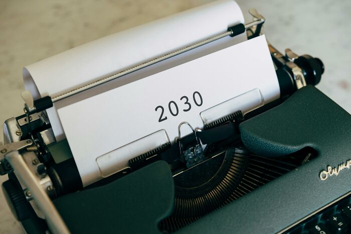 Typewriter with paper showing the year 2030, symbolizing urgency in addressing global food waste crisis facts.