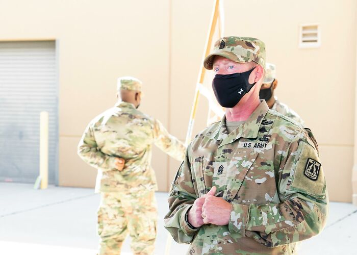 U.S. Army soldiers in uniform and masks attending a briefing, illustrating teamwork in scientists share use bodies donated science.