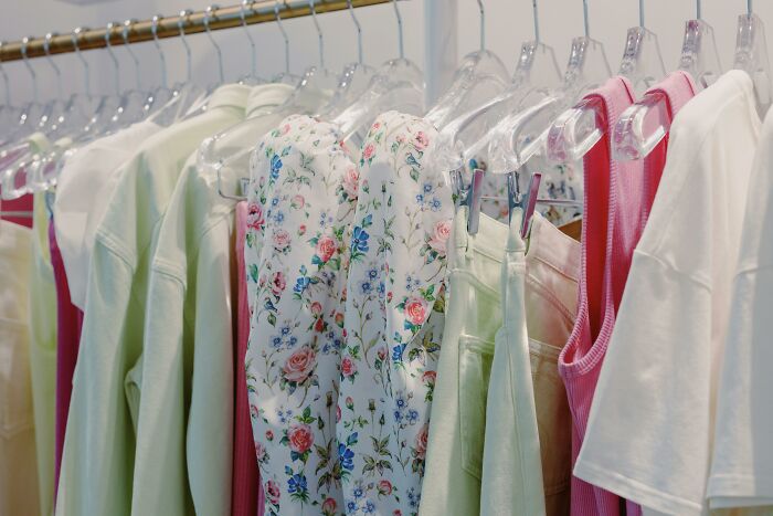 Closet full of clothes on hangers showing fashion trends contributing to overconsumption and fast clothing purchases.
