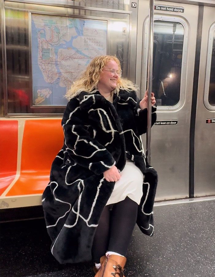 Plus-size traveler sitting on subway seat, smiling and holding a pole, highlighting issues with booking multiple airline seats. Plus-size traveler sitting on subway seat, smiling and holding a pole, highlighting issues with booking multiple airline seats.