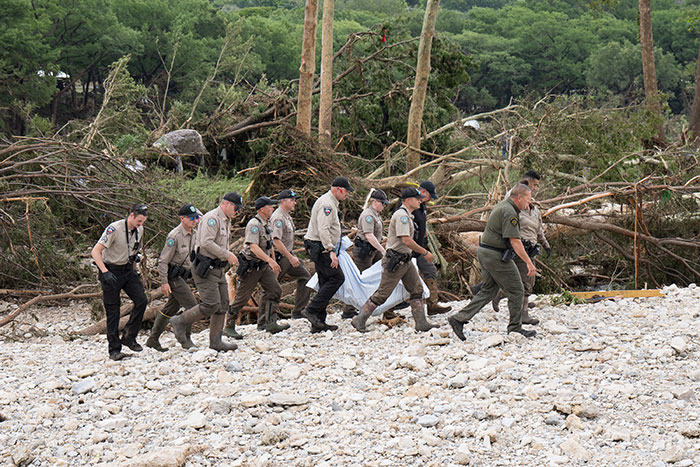 Rescue team carrying a victim through flood disaster debris, highlighting the fear and impact of the young flood victim incident. Rescue team carrying a victim through flood disaster debris, highlighting the fear and impact of the young flood victim incident.