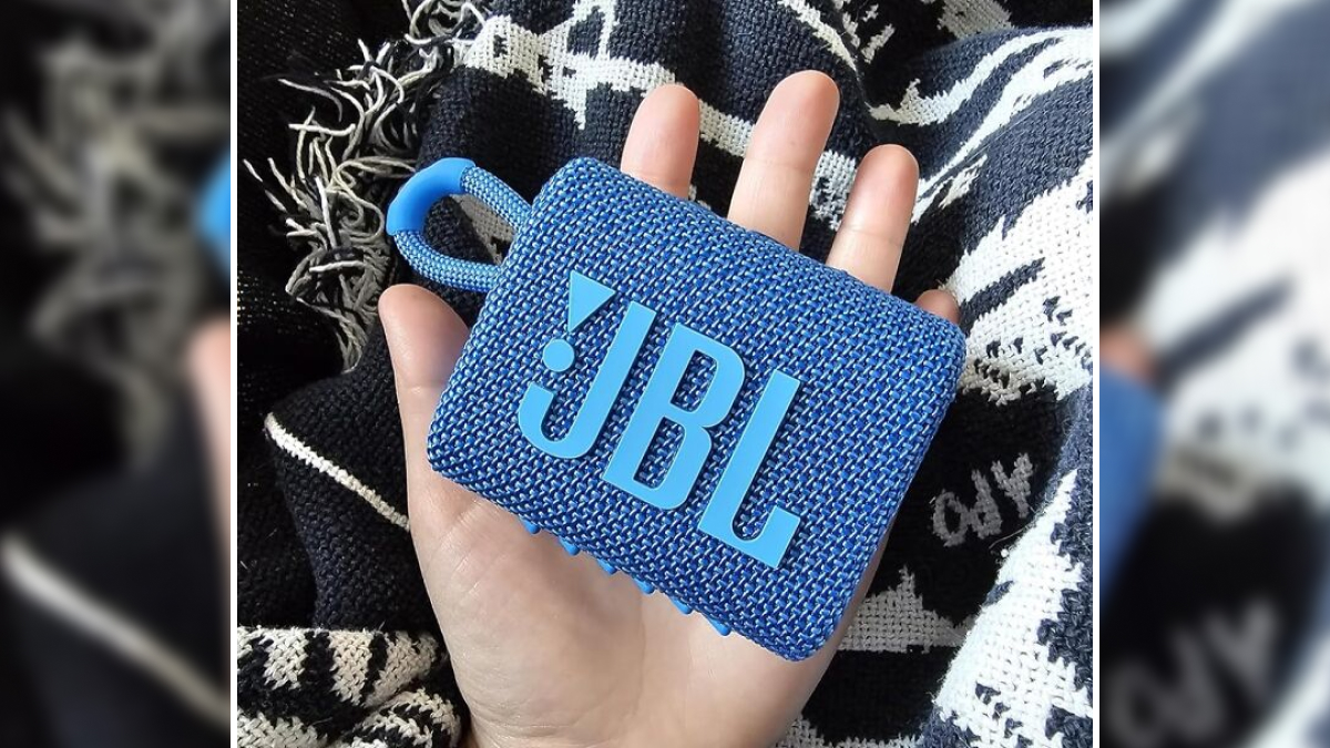 Hand holding a blue JBL portable speaker, showcasing one of the prime day electronic deals for add to cart lovers.