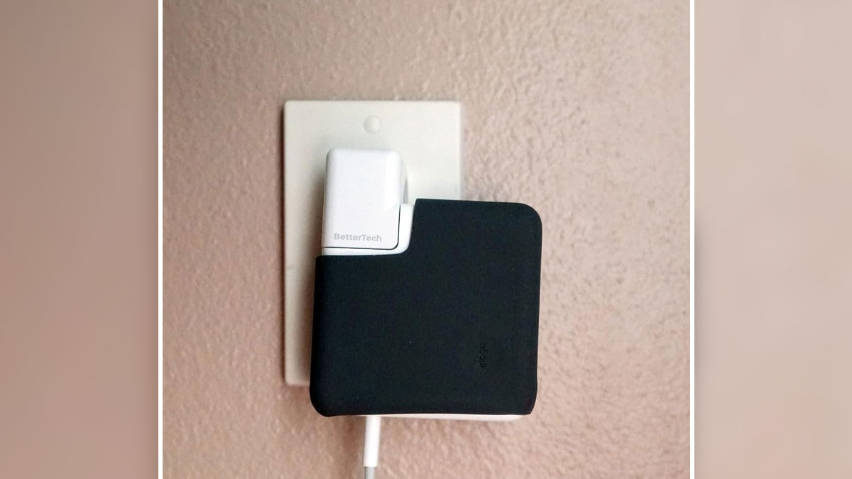 Compact gadget organizer securely attached to a power adapter, solving specific tech clutter problems efficiently.