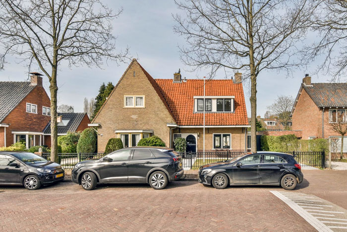 Three cars parked on a public road in front of a house where a man wrongly claims it as personal parking space Three cars parked on a public road in front of a house where a man wrongly claims it as personal parking space