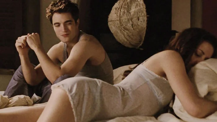 Robert Pattinson and co-star in a Twilight intimate scene, depicting a challenging moment during filming. Robert Pattinson and co-star in a Twilight intimate scene, depicting a challenging moment during filming.