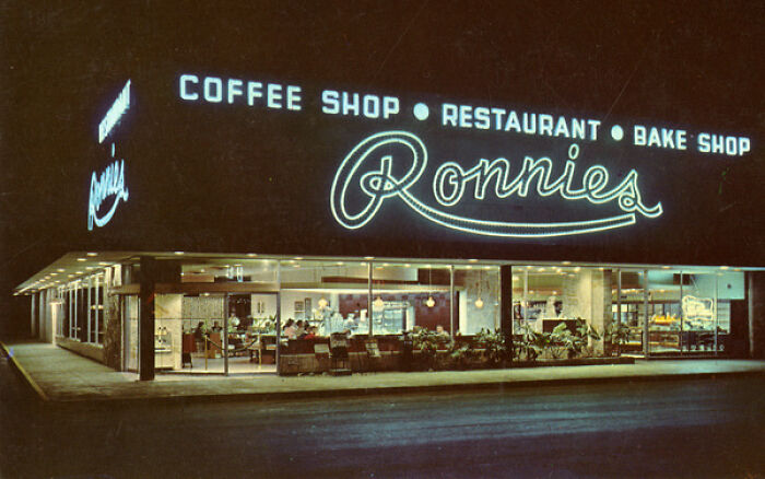 Ronnies coffee shop and restaurant at night, a captivating photo capturing daily life in the 50s across the globe.
