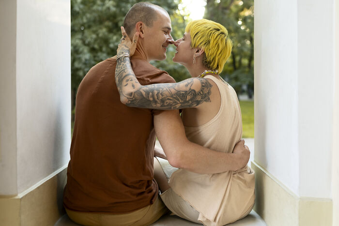 Couple embracing closely outdoors, sharing an intimate moment that reflects the impact of life-changing sentences.