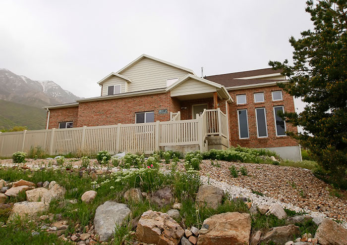 Suburban brick house surrounded by greenery and rocks, linked to Shannon Price breaking silence on Gary Coleman case. Suburban brick house surrounded by greenery and rocks, linked to Shannon Price breaking silence on Gary Coleman case.
