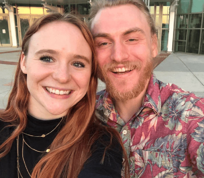 Smiling young people taking a selfie outside a building, unrelated to Virginia councilman set on fire attack news. Smiling young people taking a selfie outside a building, unrelated to Virginia councilman set on fire attack news.