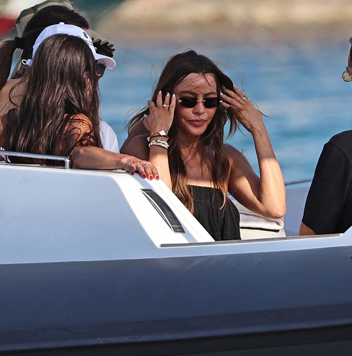 Sofía Vergara enjoying a summer romance boat ride, wearing sunglasses and black dress with friends by the sea. Sofía Vergara enjoying a summer romance boat ride, wearing sunglasses and black dress with friends by the sea.
