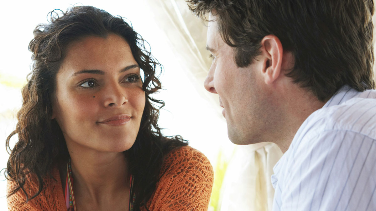 Wife looks puzzled while talking to husband about secretly owning and renting his momu2019s house like a stranger.