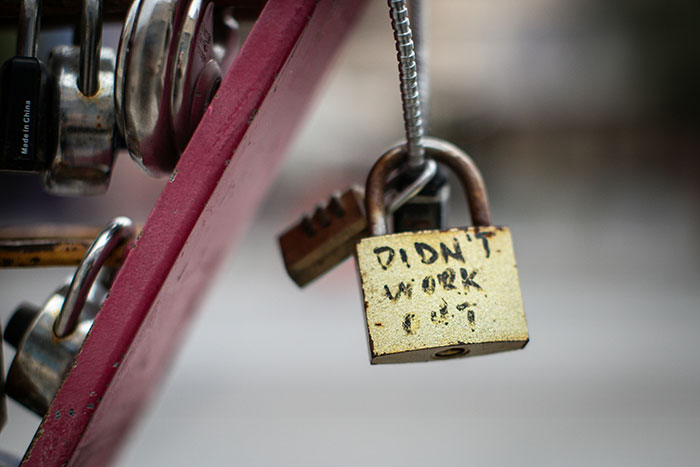 Close-up of a weathered lock with the words didn't work symbolizing a wife’s affair partner crash and divorce delay request. Close-up of a weathered lock with the words didn't work symbolizing a wife’s affair partner crash and divorce delay request.