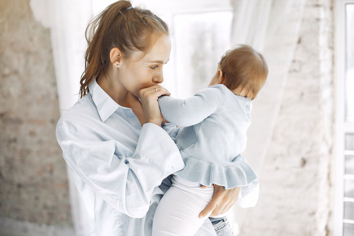 Woman holding baby, showing emotional bond and confusion, highlighting disturbed mental health and stepdaughter baby concerns. Woman holding baby, showing emotional bond and confusion, highlighting disturbed mental health and stepdaughter baby concerns.