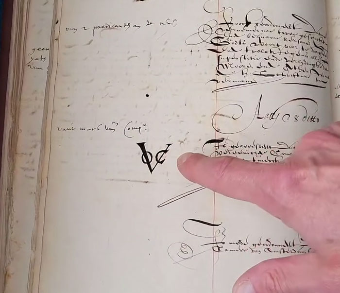 Finger pointing at text on a page from stolen historic documents resurfaced after being used as collateral to borrow money. Finger pointing at text on a page from stolen historic documents resurfaced after being used as collateral to borrow money.